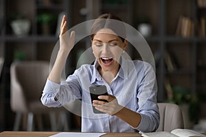 Woman read great news on cellphone scream with joy