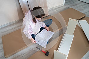 Woman Reading Assemble the furniture Manual in home