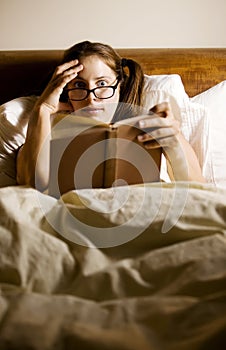 Woman Reading in Bed