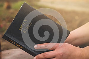 A woman is reading bible. Concept for faith, spirituality and religion.