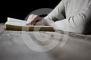 Woman reading the bible in the darkness