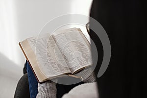 woman reading bible indoors. High quality photo