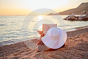 Woman reading a book on the beach