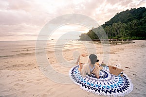 Woman is reading a book on beach