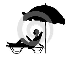 Woman reading a book on the beach silhouette.