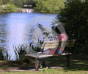 Woman reading book on bench