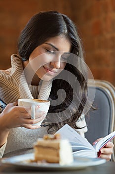 Woman reading a book at cafe