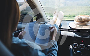 A woman reading book in the car