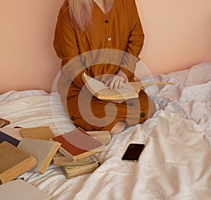 Woman reading book. Female reading book on bed