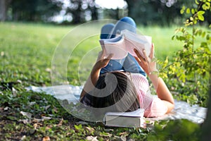 Woman reading a book in the garden.
