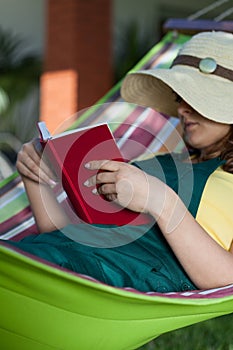 Woman reading book on a hammock