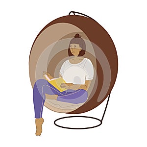 Woman reading a book in a hanging swing chair.