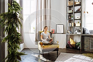 Woman reading book at home in the living room