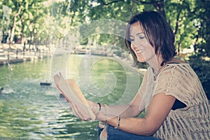 Woman reading a book in a park