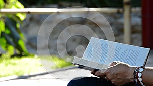 Woman reading book in a park
