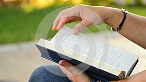 Woman reading book in a park