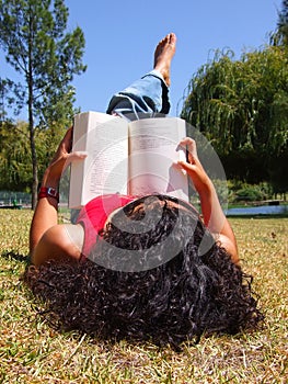 Woman reading book in park