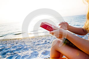 Woman reading book relaxed in deck chair