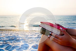 Woman reading book relaxed in deck chair