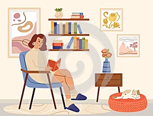 Woman reading book. Scandinavian interior, books read and relaxing. Cozy living room, girl sitting in chair and cat