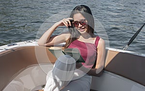 Woman reading book while sitting on boat