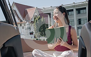 Woman reading book while sitting on boat