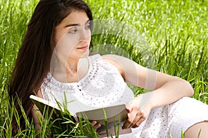 Woman reading book in spring garden