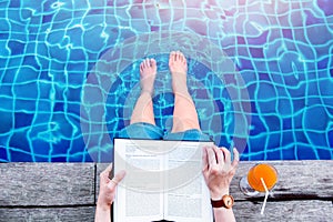 Woman Reading Book at the Swimming Pool Side, Relaxing with Summer Drink in her Vacation, Top View