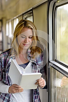 Woman reading book on train hall vacation