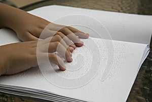Woman reading Braille book photo