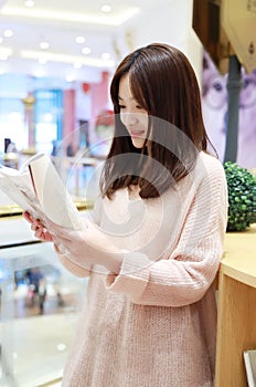 Woman reading in the Brilliantly illuminated Market