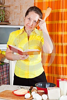 Woman reading cookbook