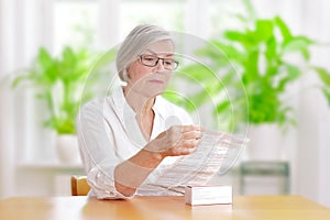 Woman reading drug package leaflet