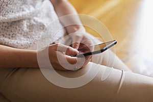 Woman reading ebook using smart phone