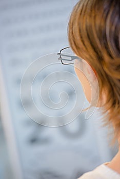 Woman reading from eye test chart