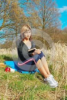 Woman Reading on Grass