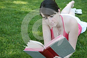 Woman reading on grass