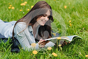 Woman reading on grass in park