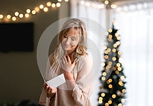 Woman reading a heartfelt message note or card