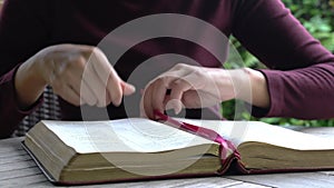 Woman reading her bible on the table.