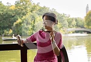 Woman reading on her phoen