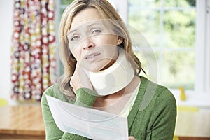 Woman Reading Letter After Receiving Neck Injury