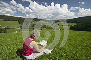 Woman reading on the meadow