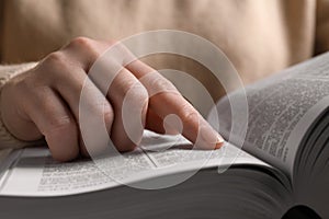 Woman reading new holy Bible, closeup view