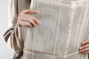 Woman reading newspaper close up view