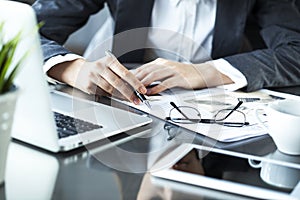 Woman reading newspaper on table