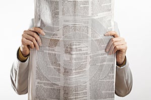 Woman reading newspaper on white background