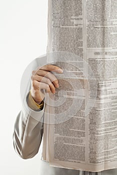 Woman reading newspaper on white background