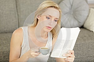 Woman reading newspaper on wooden background