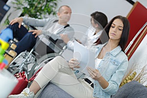 Woman reading paperwork in waiting room